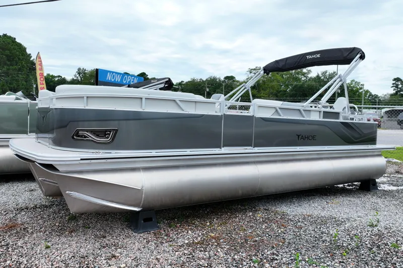 Slide: The Image of 2026 Tahoe Pontoon Sport 85 Rear Fish boat displayed outdoors on gravel. - 11