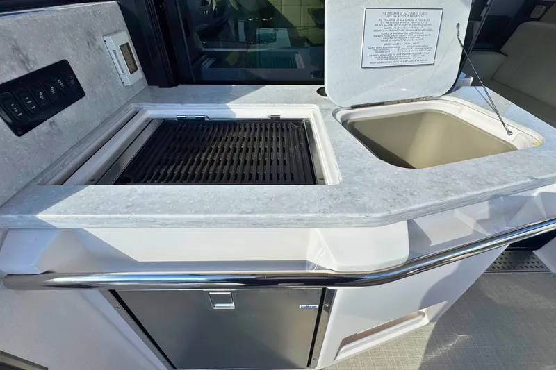 Slide: The Image of 2021 Regal 38 Grande Coupe interior with seating and wooden table. - 10