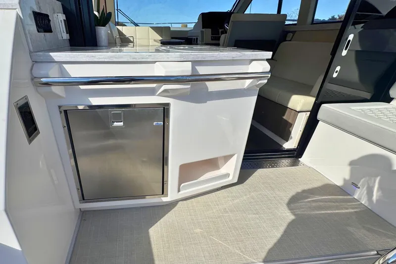 Slide: The Image of 2021 Regal 38 Grande Coupe yacht interior with open drawer-style refrigerator. - 15