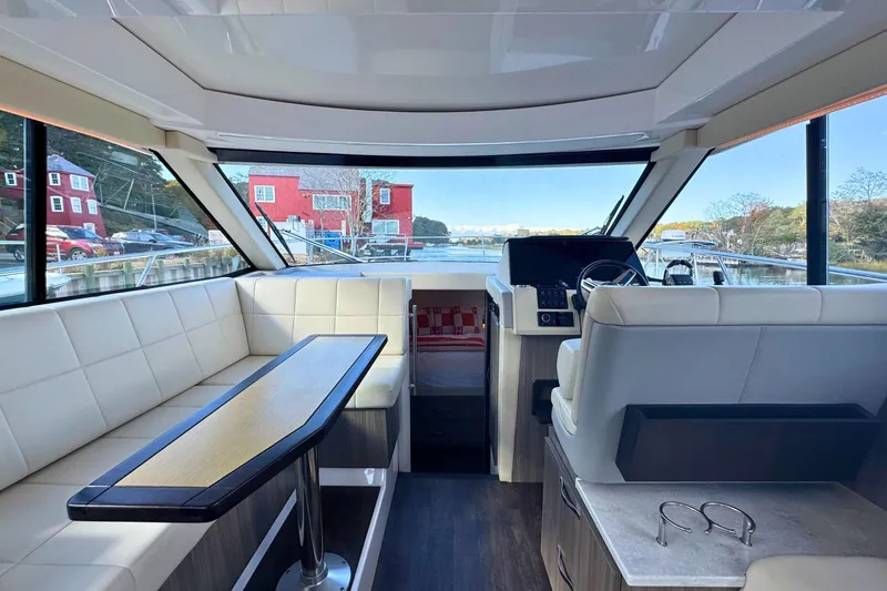 Slide: The Image of Interior of 2021 Regal 38 Grande Coupe with elegant seating and table setup. - 23