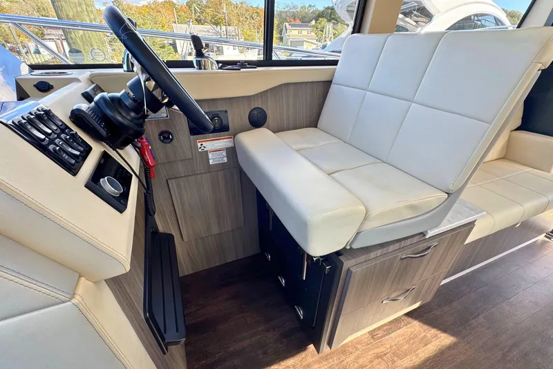 Slide: The Image of Helm of 2021 Regal 38 Grande Coupe with navigation display and controls. - 27