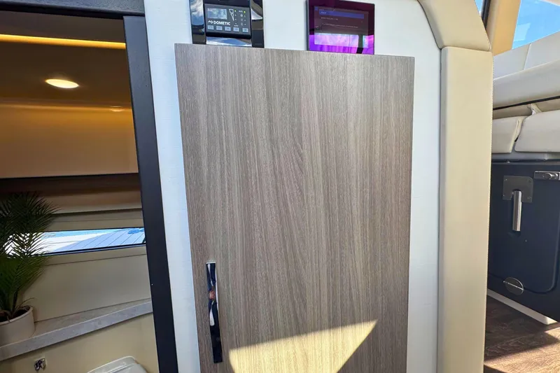 Slide: The Image of Electrical panel inside 2021 Regal 38 Grande Coupe yacht, showcasing control switches and gauges. - 30