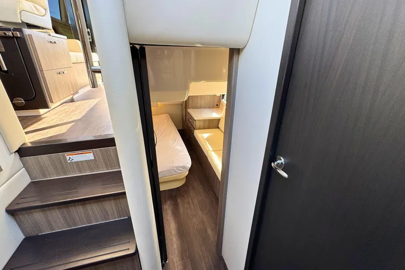 Slide: The Image of Interior of 2021 Regal 38 Grande Coupe, featuring a cozy bedroom with elegant bedding. - 33