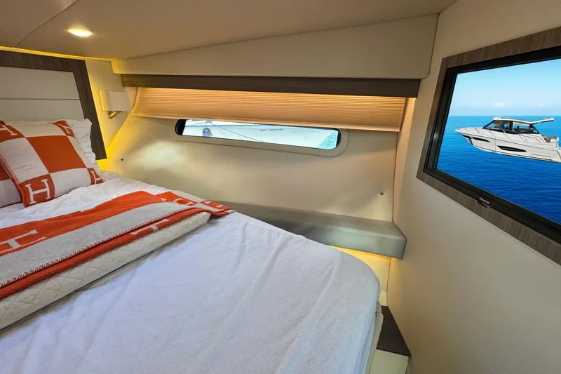 Slide: The Image of 2021 Regal 38 Grande Coupe interior cabin with stairs and cozy sleeping area. - 37