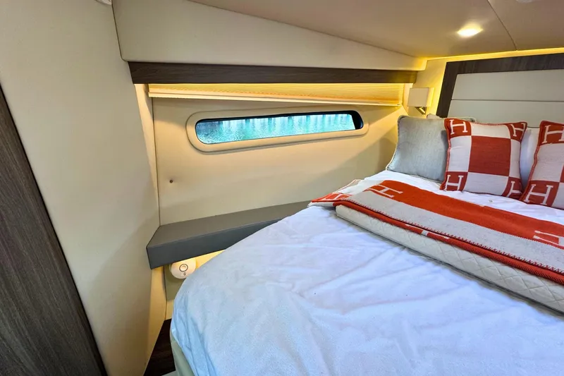 Slide: The Image of Luxurious bedroom interior of 2021 Regal 38 Grande Coupe yacht with elegant bedding. - 38