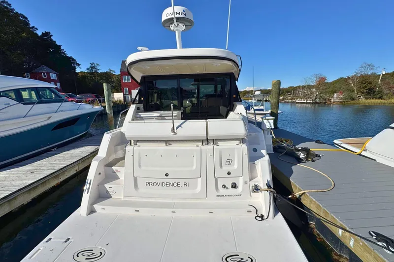 Slide: The Image of 2021 Regal 38 Grande Coupe yacht interior with seating and table, showcasing luxury design. - 5