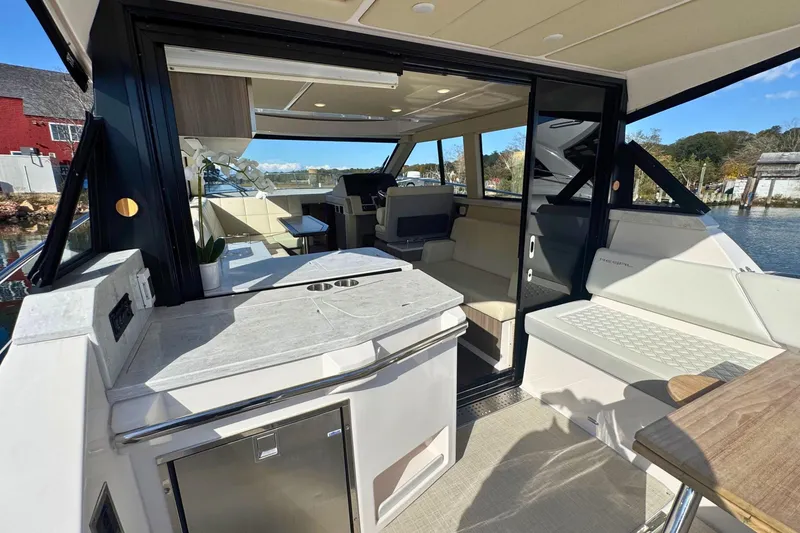 Slide: The Image of Interior of 2021 Regal 38 Grande Coupe yacht with modern kitchenette and seating area. - 8