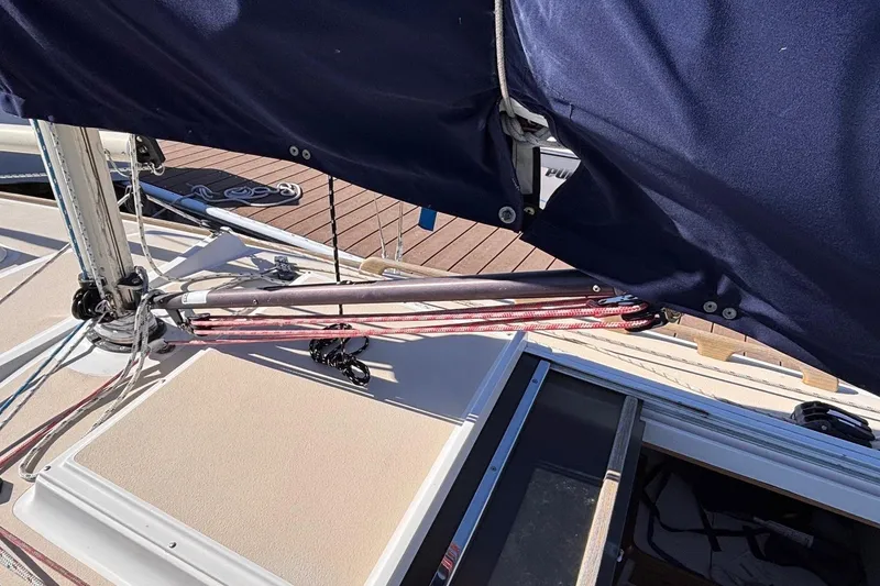 Slide: The Image of 2016 Alerion Express 28 sailboat deck with rigging and covered sail. - 11