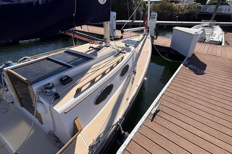 Slide: The Image of Alerion Express 28 sailboat docked, 2016 model, with sleek design and wooden accents. - 12