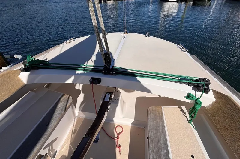 Slide: The Image of 2016 Alerion Express 28 sailboat cockpit with green ropes and wooden seating. - 18