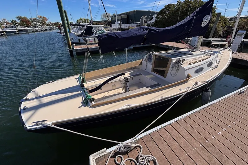 Slide: The Image of 2016 Alerion Express 28 sailboat docked at a marina, featuring sleek design and classic lines. - 2