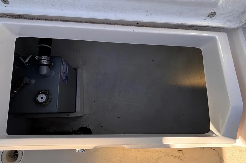 Slide: The Image of Open storage compartment in 2016 Alerion Express 28 sailboat, showing internal equipment. - 24