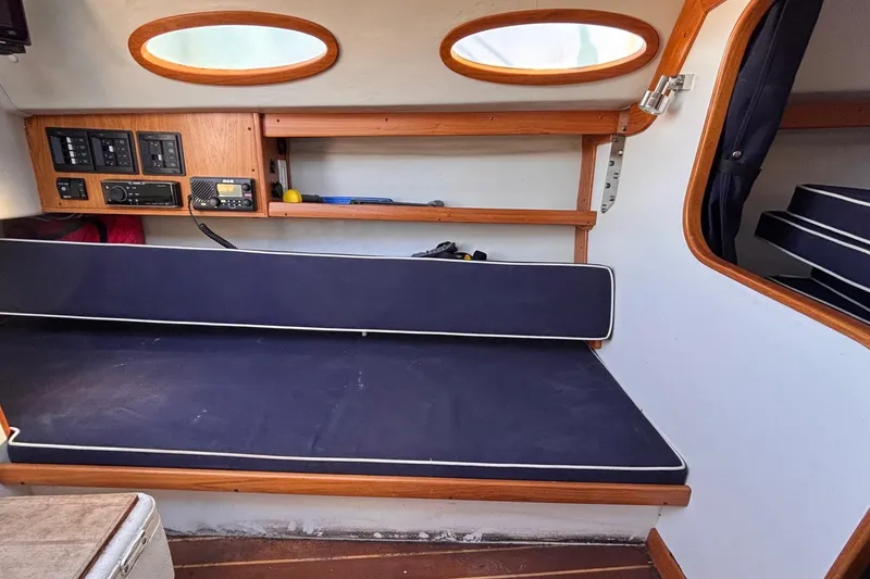 Slide: The Image of Interior of 2016 Alerion Express 28 sailboat with navy cushions and control panel. - 28