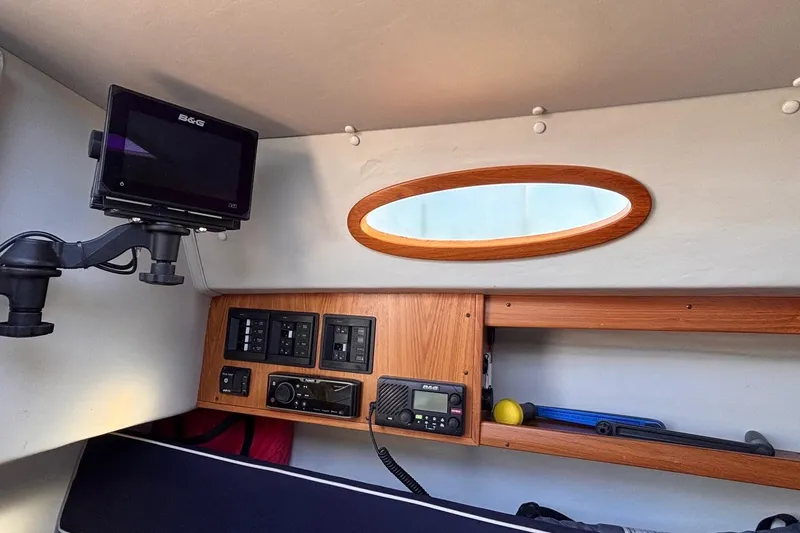 Slide: The Image of Interior of 2016 Alerion Express 28 sailboat with navigation equipment and wooden cabinetry. - 30