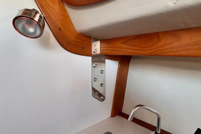 Slide: The Image of Interior detail of 2016 Alerion Express 28 sailboat, featuring wood trim and metal fixtures. - 34