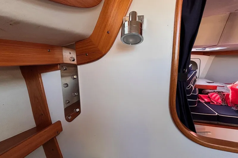 Slide: The Image of Interior of 2016 Alerion Express 28 sailboat with wooden trim and cabin view. - 35