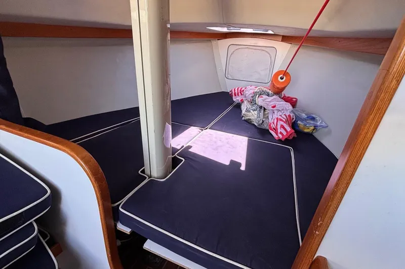 Slide: The Image of Interior cabin of a 2016 Alerion Express 28 sailboat with navy cushions. - 36