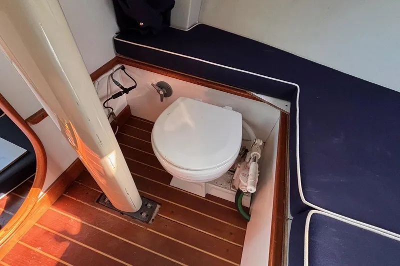 Slide: The Image of Alerion Express 28 (2016) boat interior with toilet and wooden flooring. - 40