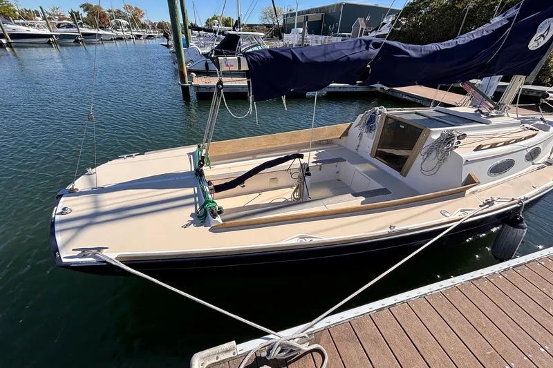 Slide: The Image of 2016 Alerion Express 28 sailboat docked in a marina, featuring a sleek design. - 5