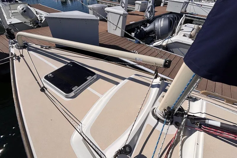Slide: The Image of 2016 Alerion Express 28 sailboat deck with rigging and hatch, docked at marina. - 8