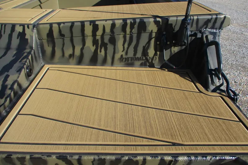 Slide: The Image of 2026 Gator Tail 1750 Savage Mid Deck with camouflage pattern and textured flooring. - 10