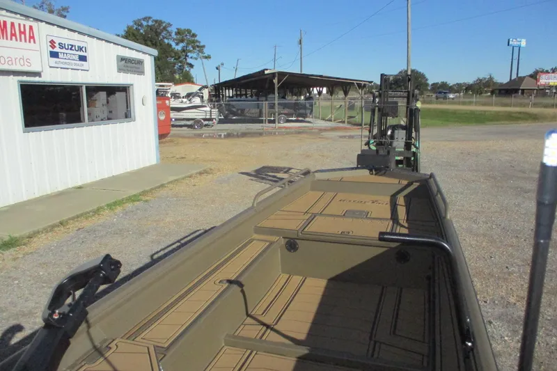 Slide: The Image of 2026 Gator Tail 1750 Savage Mid Deck boat at a marine dealership. - 11