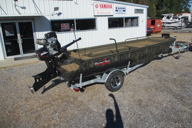 Slide: The Image of 2026 Gator Tail 1750 Savage Mid Deck boat on trailer outside dealership. - 2