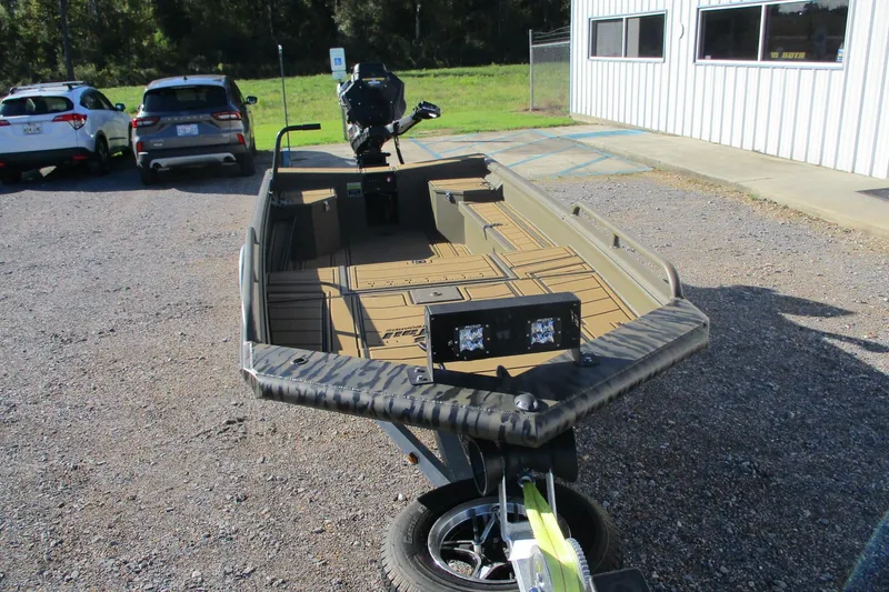 Slide: The Image of 2026 Gator Tail 1750 Savage Mid Deck boat parked outdoors on gravel. - 7