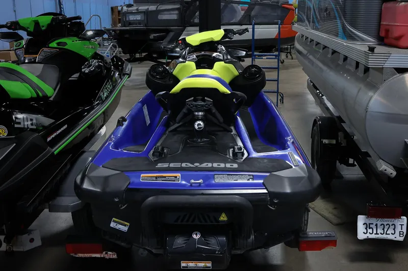 Slide: The Image of 2020 Sea Doo 170 jet ski in a storage facility, surrounded by other watercraft. - 3