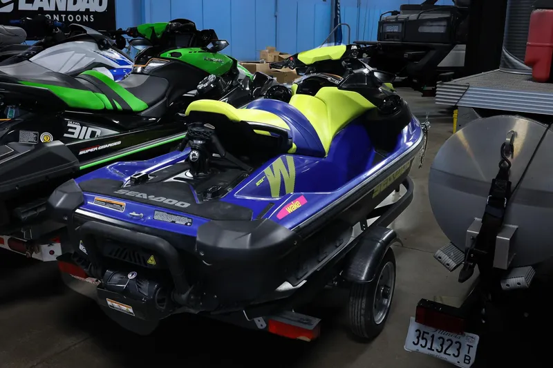 Slide: The Image of 2020 Sea Doo 170 jet ski with vibrant yellow and blue design in a showroom. - 5