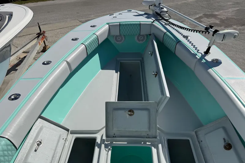 Slide: The Image of 2018 Latitude Tournament Boats Competitor 25 with open storage compartments and teal interior. - 13
