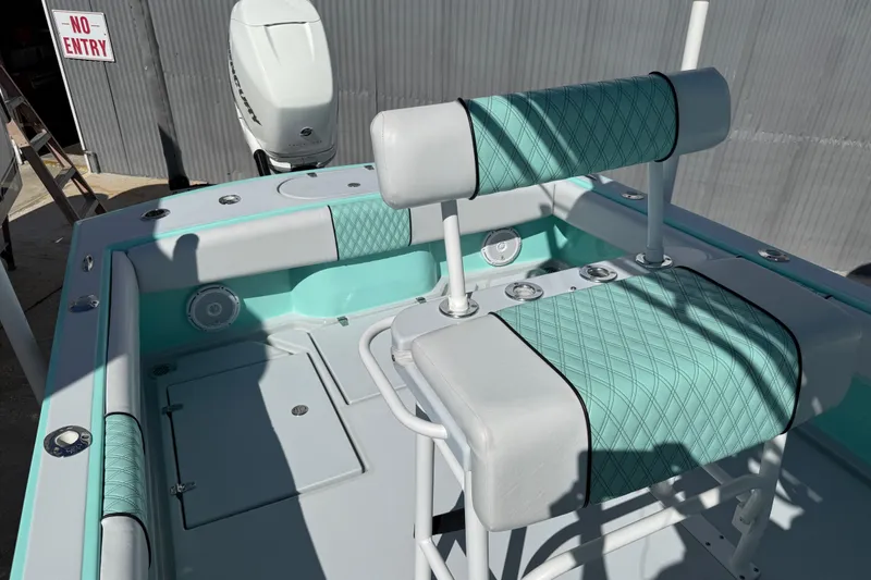 Slide: The Image of 2018 Latitude Tournament Boats Competitor 25 with teal and white seating, docked near "No Entry" sign. - 16