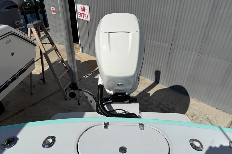 Slide: The Image of 2018 Latitude Tournament Boats Competitor 25 with outboard motor, docked near a "No Entry" sign. - 20
