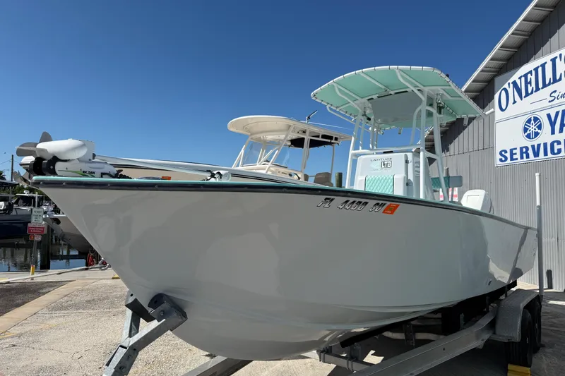 Slide: The Image of 2018 Latitude Tournament Boats Competitor 25 on trailer at marina, clear blue sky. - 3