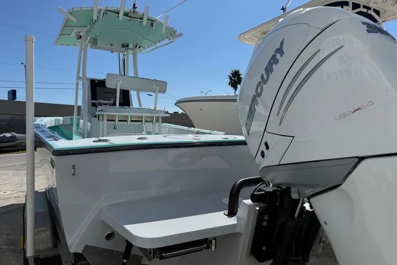 Slide: The Image of 2018 Latitude Tournament Boats Competitor 25 with Mercury Verado engine, docked under clear sky. - 5