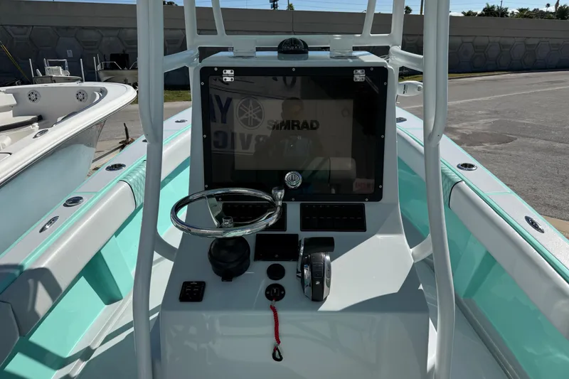 Slide: The Image of 2018 Latitude Tournament Boats Competitor 25 console with steering wheel and controls. - 8