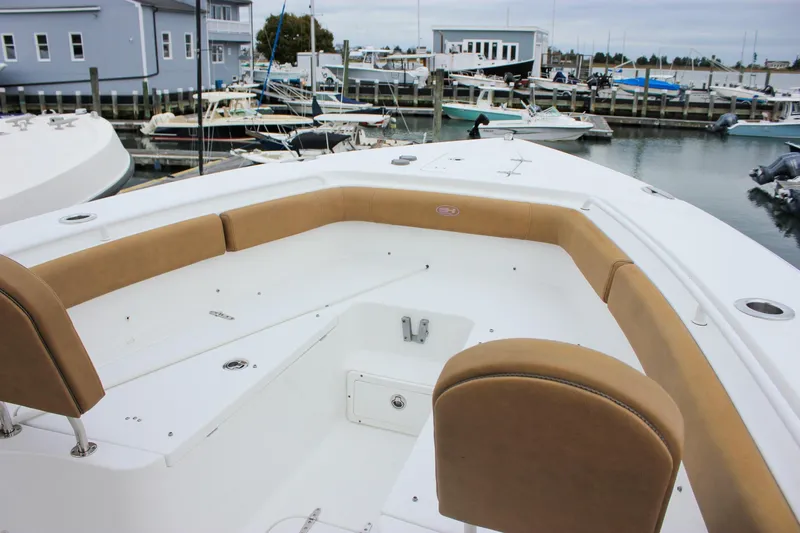 Slide: The Image of 2020 Sea Hunt Ultra 275 SE boat with tan seating, docked in a marina. - 10