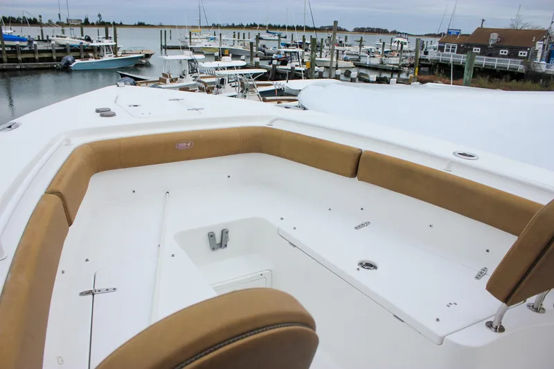 Slide: The Image of 2020 Sea Hunt Ultra 275 SE boat with spacious seating, docked at marina. - 11