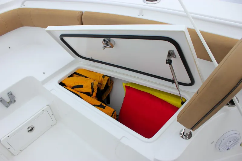 Slide: The Image of Open storage compartment on 2020 Sea Hunt Ultra 275 SE boat with life jackets. - 15