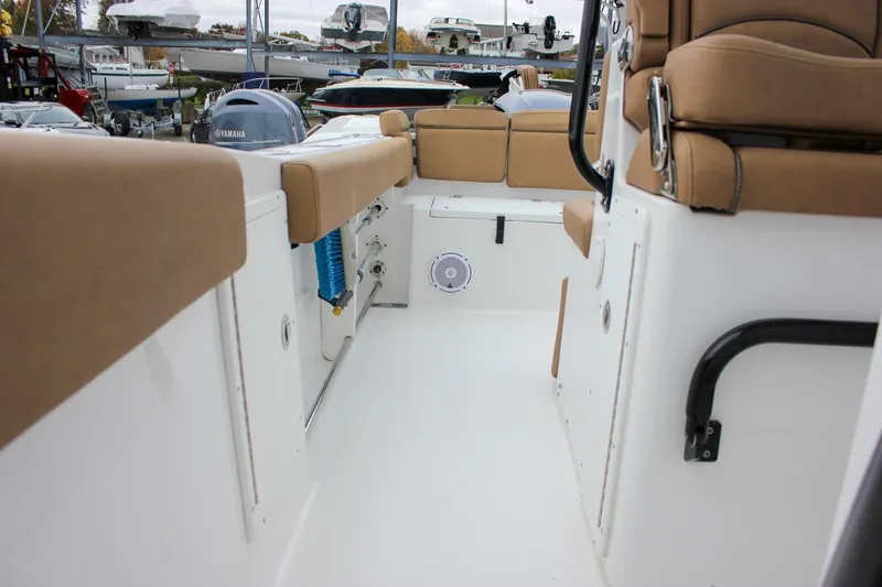 Slide: The Image of 2020 Sea Hunt Ultra 275 SE boat interior with tan seating and Yamaha engine. - 17