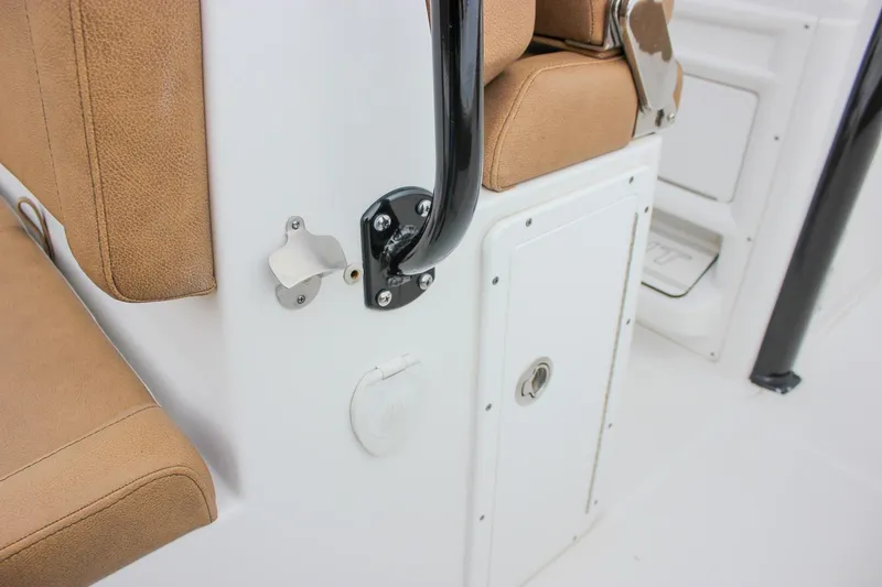 Slide: The Image of 2020 Sea Hunt Ultra 275 SE boat interior with tan seating and storage compartment. - 20