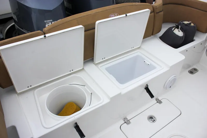 Slide: The Image of 2020 Sea Hunt Ultra 275 SE boat storage compartments with open lids and accessories. - 21