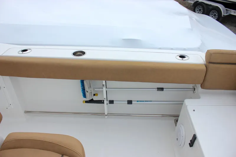 Slide: The Image of 2020 Sea Hunt Ultra 275 SE boat interior with tan seating and storage area. - 22