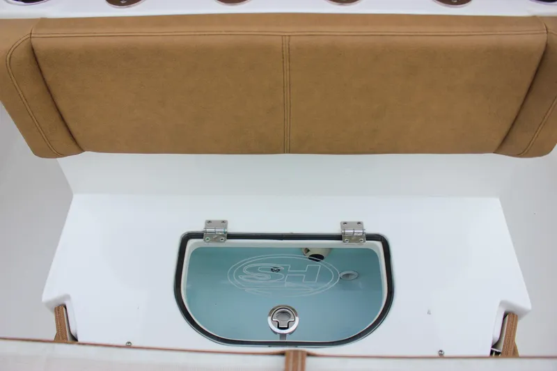 Slide: The Image of 2020 Sea Hunt Ultra 275 SE boat interior with tan seating and storage compartment. - 26