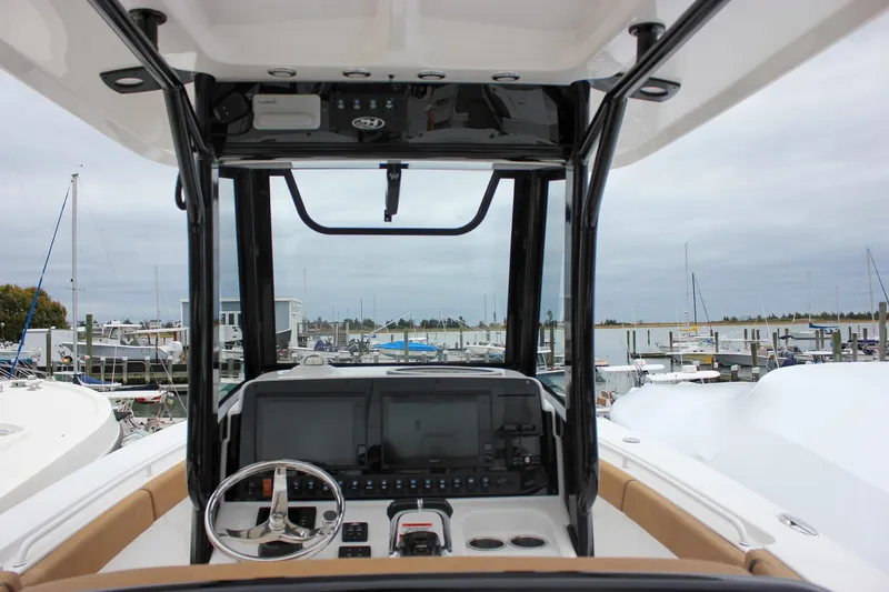 Slide: The Image of 2020 Sea Hunt Ultra 275 SE boat dashboard with marina view. - 3