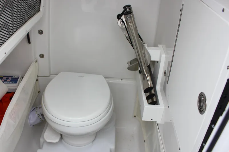 Slide: The Image of 2020 Sea Hunt Ultra 275 SE boat interior with toilet and storage compartment. - 32