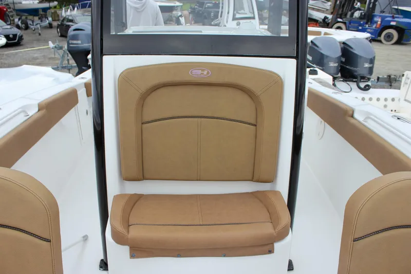 Slide: The Image of 2020 Sea Hunt Ultra 275 SE boat interior with tan seating and dual engines. - 36