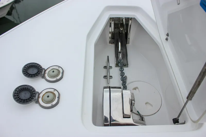 Slide: The Image of Anchor compartment of 2020 Sea Hunt Ultra 275 SE boat, featuring chain and winch system. - 37