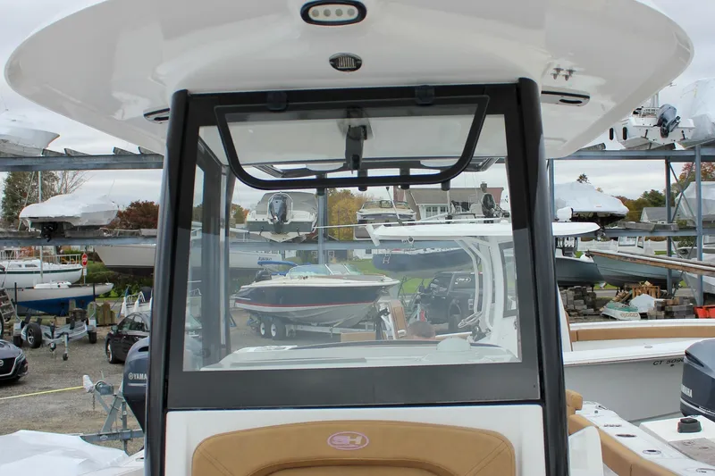 Slide: The Image of 2020 Sea Hunt Ultra 275 SE boat in a marina with other vessels. - 38