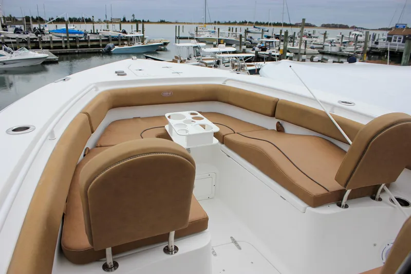 Slide: The Image of 2020 Sea Hunt Ultra 275 SE boat with tan seating, docked at marina. - 39